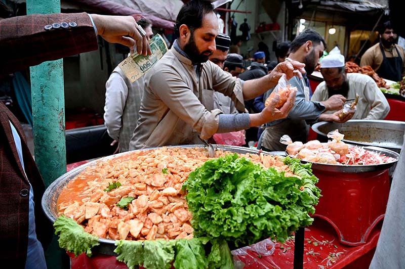 Vendors selling traditional food Kachalu Pera during Ramadan.