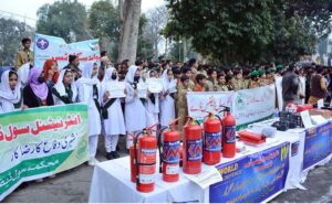 Members of the Boy Scouts and students participating in a walk to mark International Civil Defence Day at Zilla Council Chowk