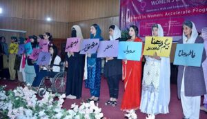 Students participating in scooty march and walk to mark International Women's Day at Government College for Women University (GCWUF) Madina Town.