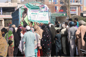 People carrying flour bags on their head provided by the Government on subsidized rate.