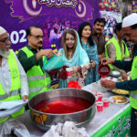 Volunteers distribute the drink for needy people sitting for Iftar arranged by Sohni Dharti Youth Council at Hyder Chowk