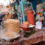 A workers preparing sweet food item Paeonia for customers at their workplace.