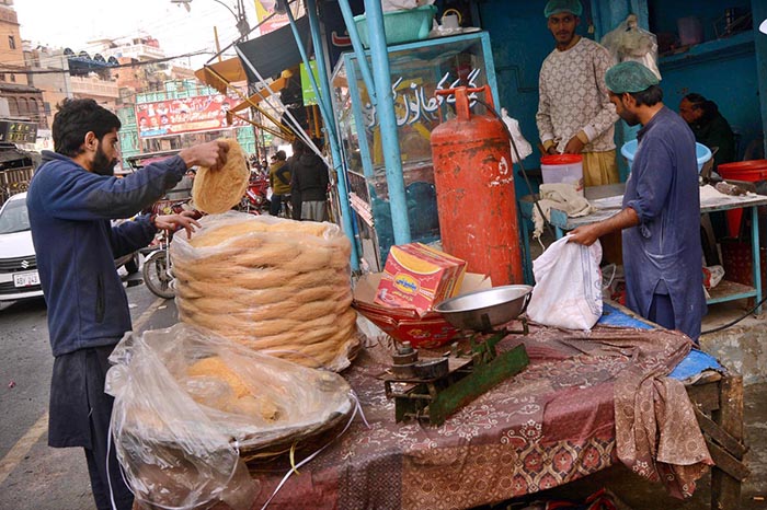 A workers preparing sweet food item Paeonia for customers at their workplace.