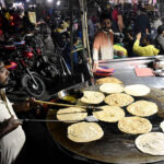 Vendors preparing traditional food stuff (Parathas) for Sehri at a local market during Holy Fasting Month of Ramzanul Mubarak