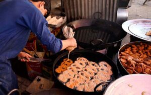 Vendor busy in making traditional sweet item Jalebi for customers during Ramadan.