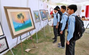 School students look at the stall of animal figurines set by Sher Bagh Museum Zoo on the second day of the Annual Celebration of Spring Flower Competition.