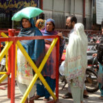 Woman carrying flour bag provided by the Government on subsidies rate