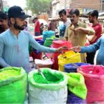Hindu community purchasing color’s from vendor during Holi festival at tower market