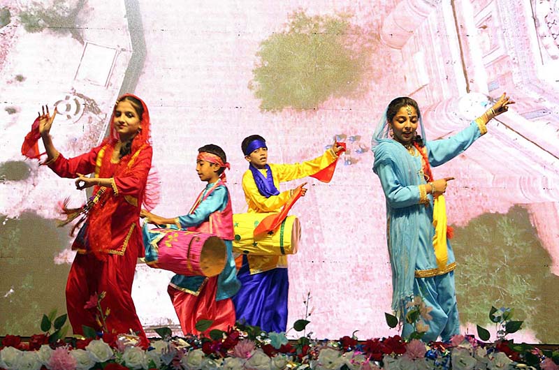Students performing in tableau on the stage during annual function of the local school at Mehran Art Council