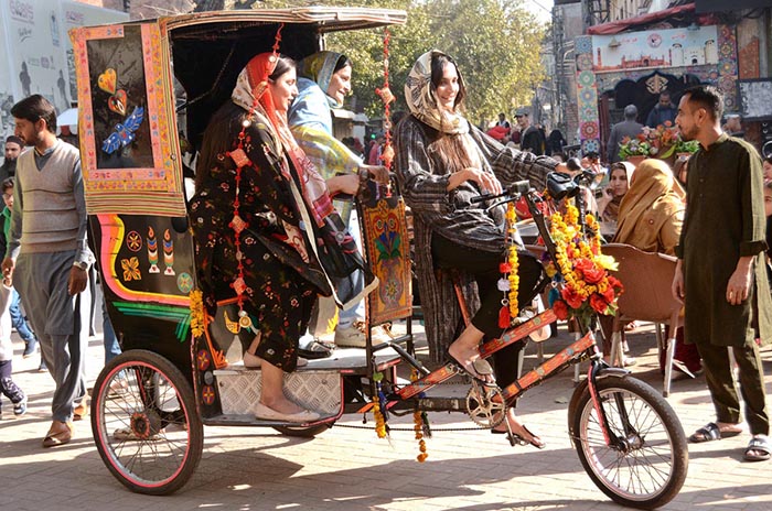 People enjoy riding tricycle rikshaw at Food Street.