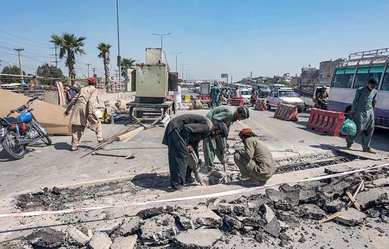 Labourers busy in fixing a damaged road at Pirwadhai Chowk in the city.
