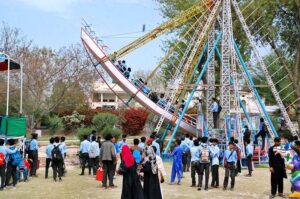 School students look at the stall of animal figurines set by Sher Bagh Museum Zoo on the second day of the Annual Celebration of Spring Flower Competition.