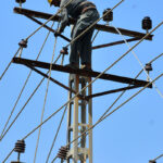 WAPDA worker busy in installed electricity cable on the electric pole at Autobahn Road