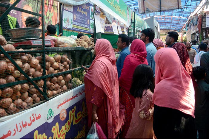 People purchasing vegetables from Ramzan Bachat Bazar organized by local government during Holy month of Ramadan at Model Bazar Johar Town.