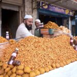 A vendor selling food items on his shop at Muslim bazar