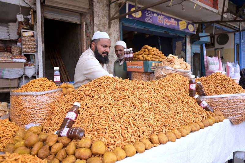 A vendor selling food items on his shop at Muslim bazar