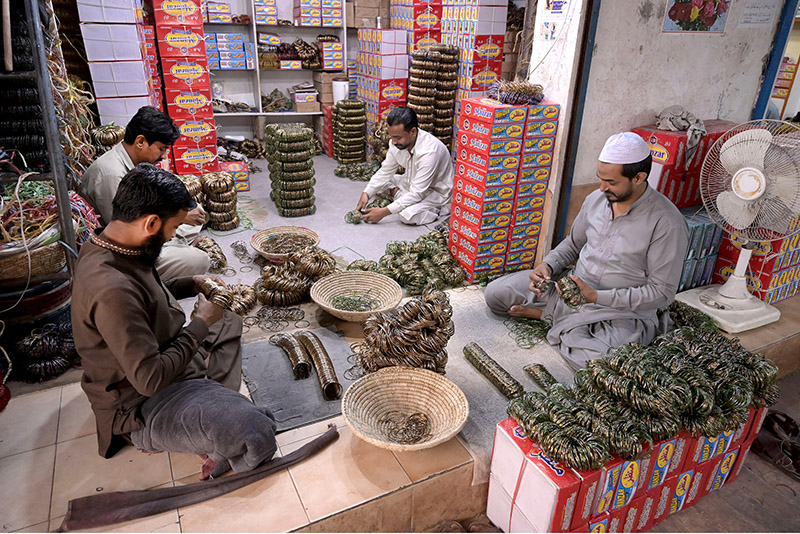 Workers sorting and packing bangles at their workplace in Bangles Market.