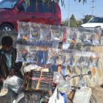 A vendor selling fishes to attract customers at Roadside