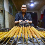 Vendor preparing traditional Seekh Kabab to attract the customers during Ramadan at Namak Mandi Road