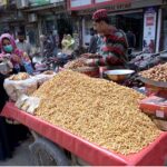 A vendor selling food items on his cart at Gole Chowk in the City
