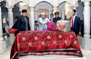 President Asif Ali Zardari showering flowers on the grave of Shaheed Mohtarma Benazir Bhutto at Garhi Khuda Bakhsh Bhutto.
