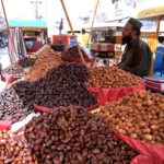 A vendor selling dates on his cart at Muslim bazar