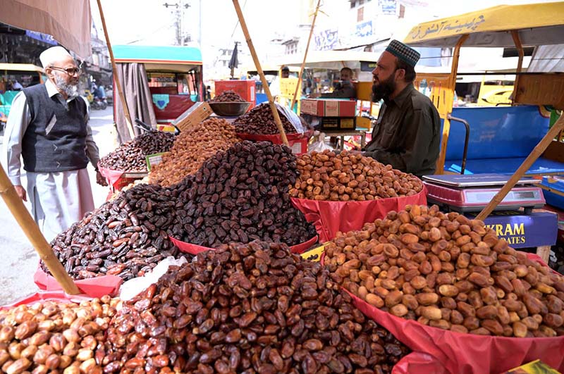 A vendor selling dates on his cart at Muslim bazar