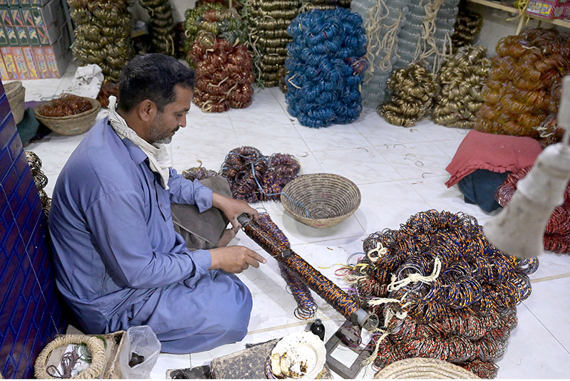 Workers sorting and packing bangles at their workplace in Bangles Market.