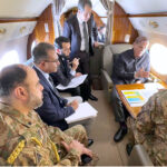 Prime Minister Muhammad Shehbaz Sharif receives briefing from Chairman NDMA Lt. General Inam Haider Malik regarding rescue and relief activities for the affectees of recent torrential rains in aircraft en route Gwadar.