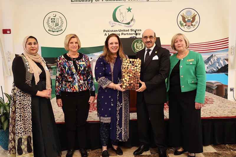 Ambassador Masood Khan addressing a jam-packed hall with a large number of women participants during an event held at the Embassy of Pakistan celebrating Pakistan's cultural treasures and the stunning landscape featuring traditional apparel, delicious cuisine, and exquisite artwork