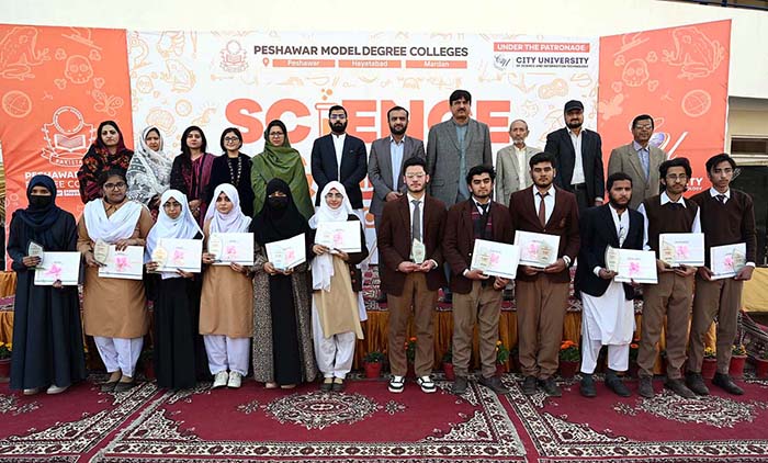 Female student busy in calligraphy during Science and Art exhibition arranged by Peshawar Model Degree Colleges