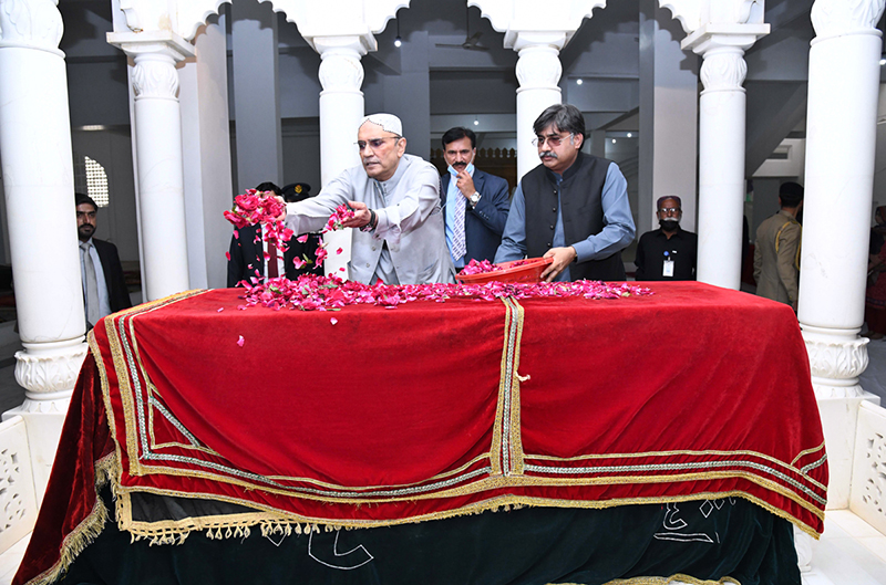 President Asif Ali Zardari showering flowers on the grave of Shaheed Mohtarma Benazir Bhutto at Garhi Khuda Bakhsh Bhutto.