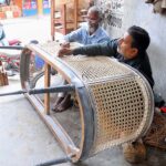 Workers are busy knitting a couch sofa at their workplace