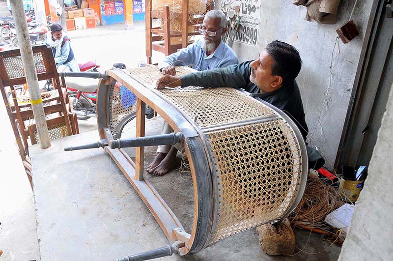 Workers are busy knitting a couch sofa at their workplace