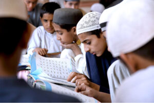 Students reciting verses of Holy Quran in a local madrasa at Dodai Road during Holy Fasting Month of Ramzan