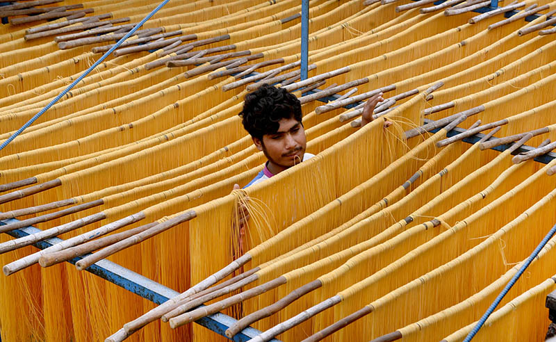 A worker preparing vermicelli as per increased demand of customers to be used during Eid-ul- Fitr celebrations.