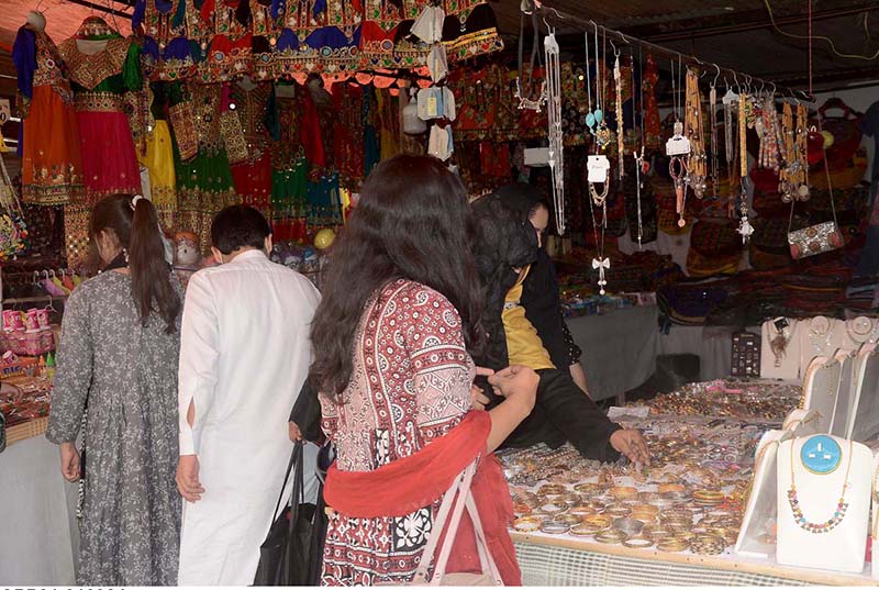 Women purchasing bangles and henna for upcoming Eid ul Fitr Festival.