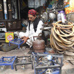 A person repairing gas cylinder stoves at his workplace