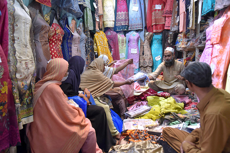 Women shopping clothes in cloth market in preparations of Eid-ul-Fitr in the city