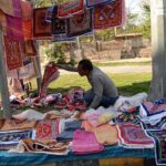 Vendor is displaying and selling bread cloth and towels to attract customers at roadside