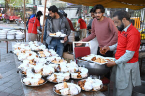 Volunteers preparing food to distribute among the people in fast during the Holy Month of Ramadan at Satellite Town.