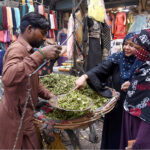 Women buying Kachnar vegetables in the bazaar