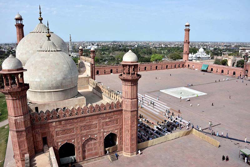 People arrive in Historical Badshahi Mosque to offer Friday prayers during the Islamic holy fasting month of Ramadan.