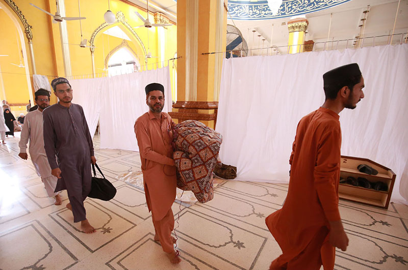 People with their luggage to observe Itekaaf as the last ten days of the holy month of Ramadan begins.