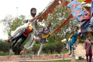 Children enjoying swing during the Jashn-e-Baharan festival organized by PHA at Qasim Bagh