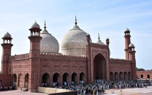 People arrive in Historical Badshahi Mosque to offer Friday prayers during the Islamic holy fasting month of Ramadan.