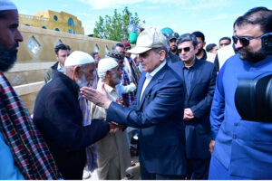 Prime Minister Muhammad Shehbaz Sharif consoling the affectees of torrential rains at a relief camp.