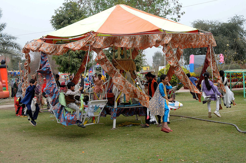 Children enjoying swing during the Jashn-e-Baharan festival organized by PHA at Qasim Bagh