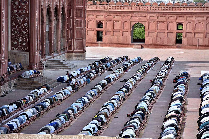 People offer Friday prayers during the Islamic holy fasting month of Ramadan in Historical Badshahi Mosque.