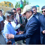 Prime Minister Muhammad Shehbaz Sharif consoling the affectees of torrential rains at a relief camp.